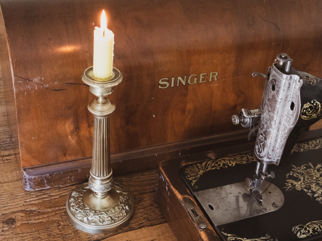 Vintage candlestick and vintage sewing machine