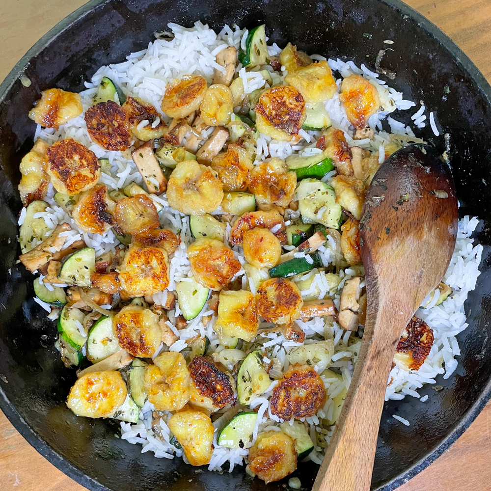 Banana and zucchini stir fry with onion and tofu, on cardamon rice